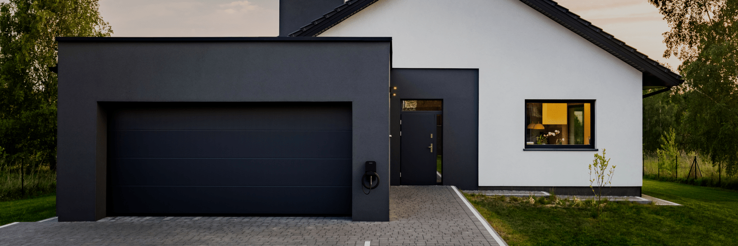 Flo Home Black X8 EV charging stations, installed outside a modern house during summer