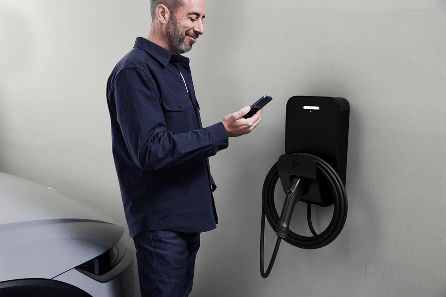 Flo Home Black Residential X8 EV charging stations installed in house, men using FLo Smartphone app for charging instructions