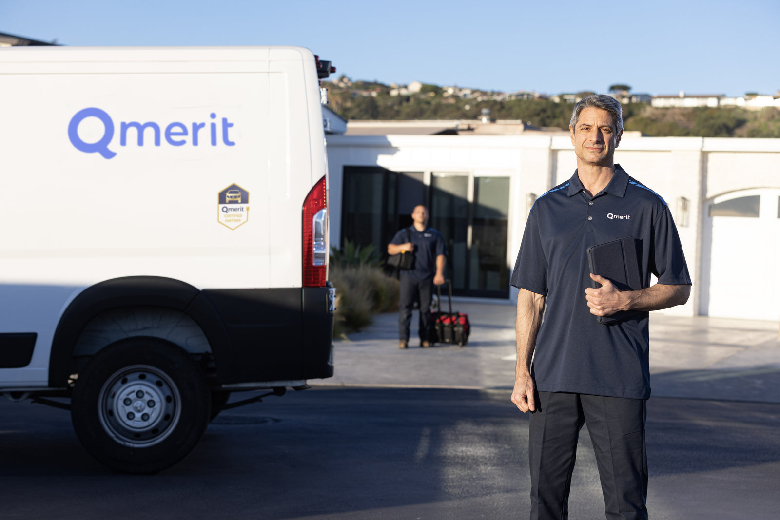 Qmerit installation van in front of house with person