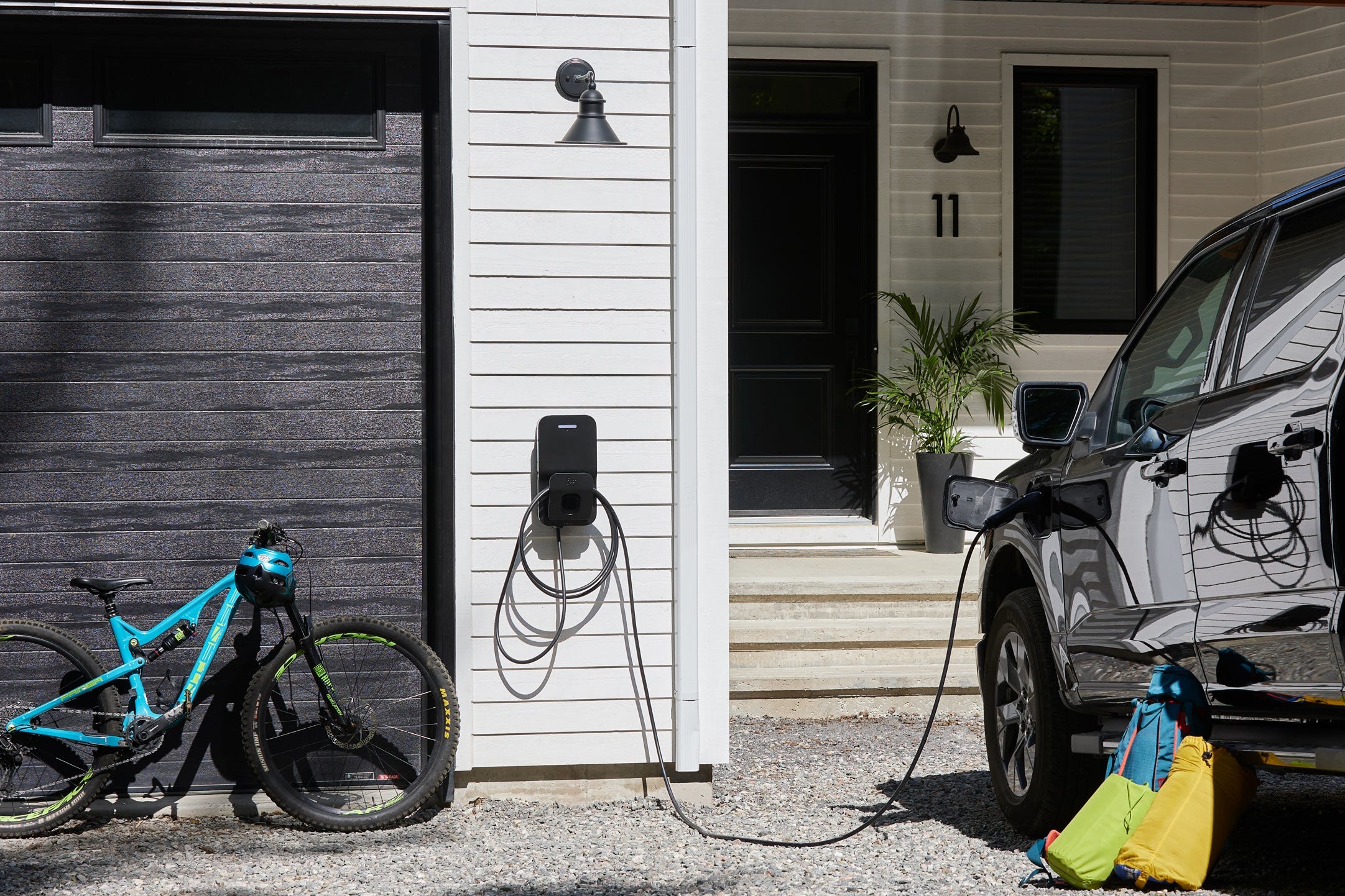 Flo Home X8 EV charging stations installed outside of a residential home, summer time 